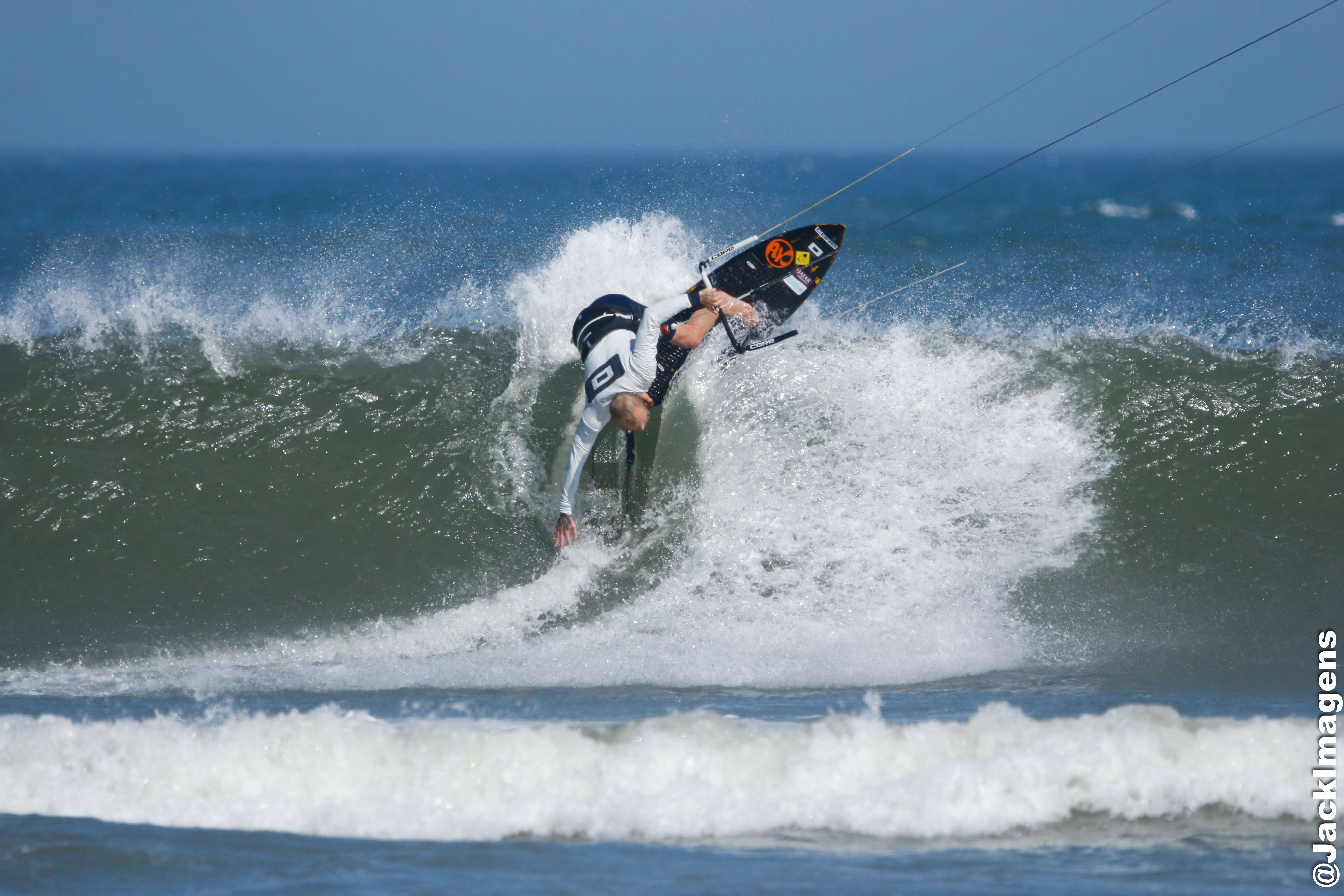Professional kitesurfer performing maneuver with AK board