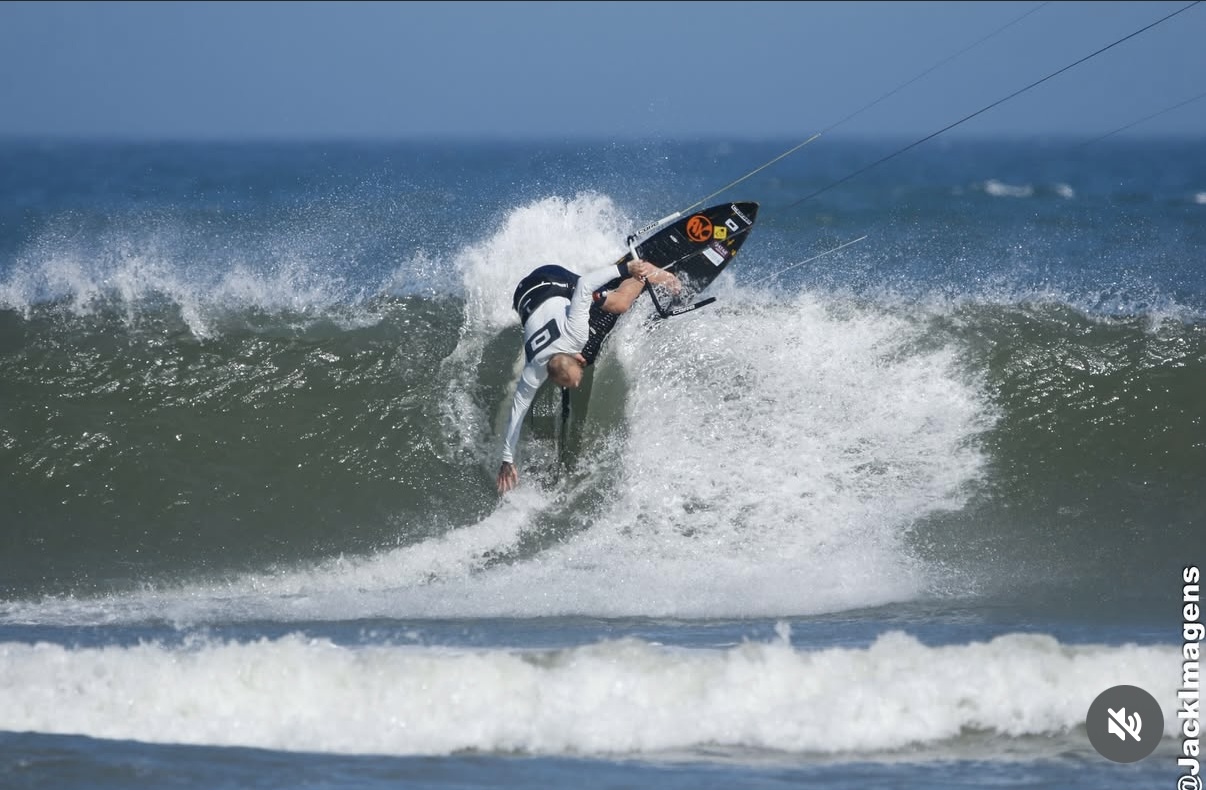 Professional kitesurfer performing maneuver with AK board
